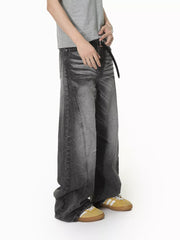 Men's dark wash wide leg jeans with a relaxed fit and drawstring detail.
