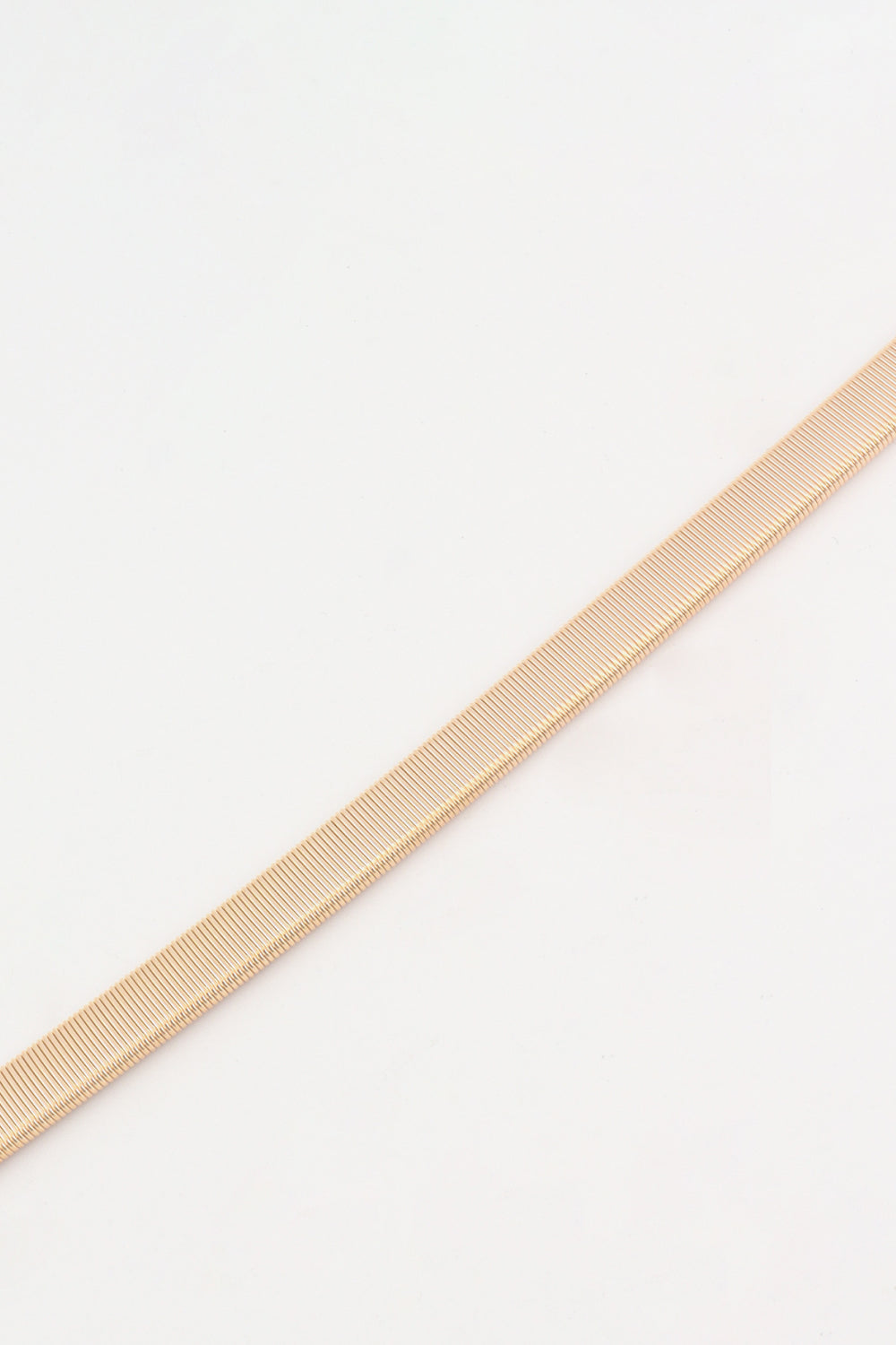 Slimline rose gold elastic waist belt with ribbed texture detail