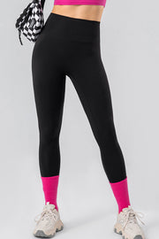 Black high-waist performance leggings with hot pink socks and sneakers
