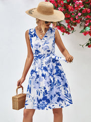 Blue watercolor floral tiered mini dress with V-neck and belted waist.