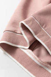 Dusty pink cardigan with white varsity trim detail on ribbed cuffs and hem.
