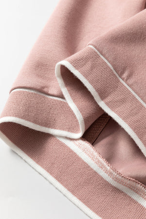 Dusty pink cardigan with white varsity trim detail on ribbed cuffs and hem.