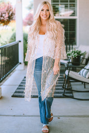 Beige sequin duster with flared sleeves and open front, worn over a white tank and jeans.