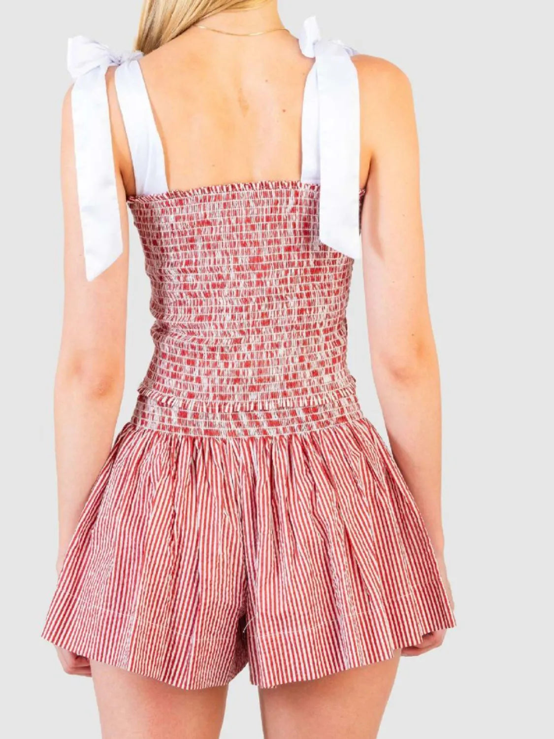 Strawberry smocked bodice and skirt set with white tie straps and red and white pinstripe skirt.