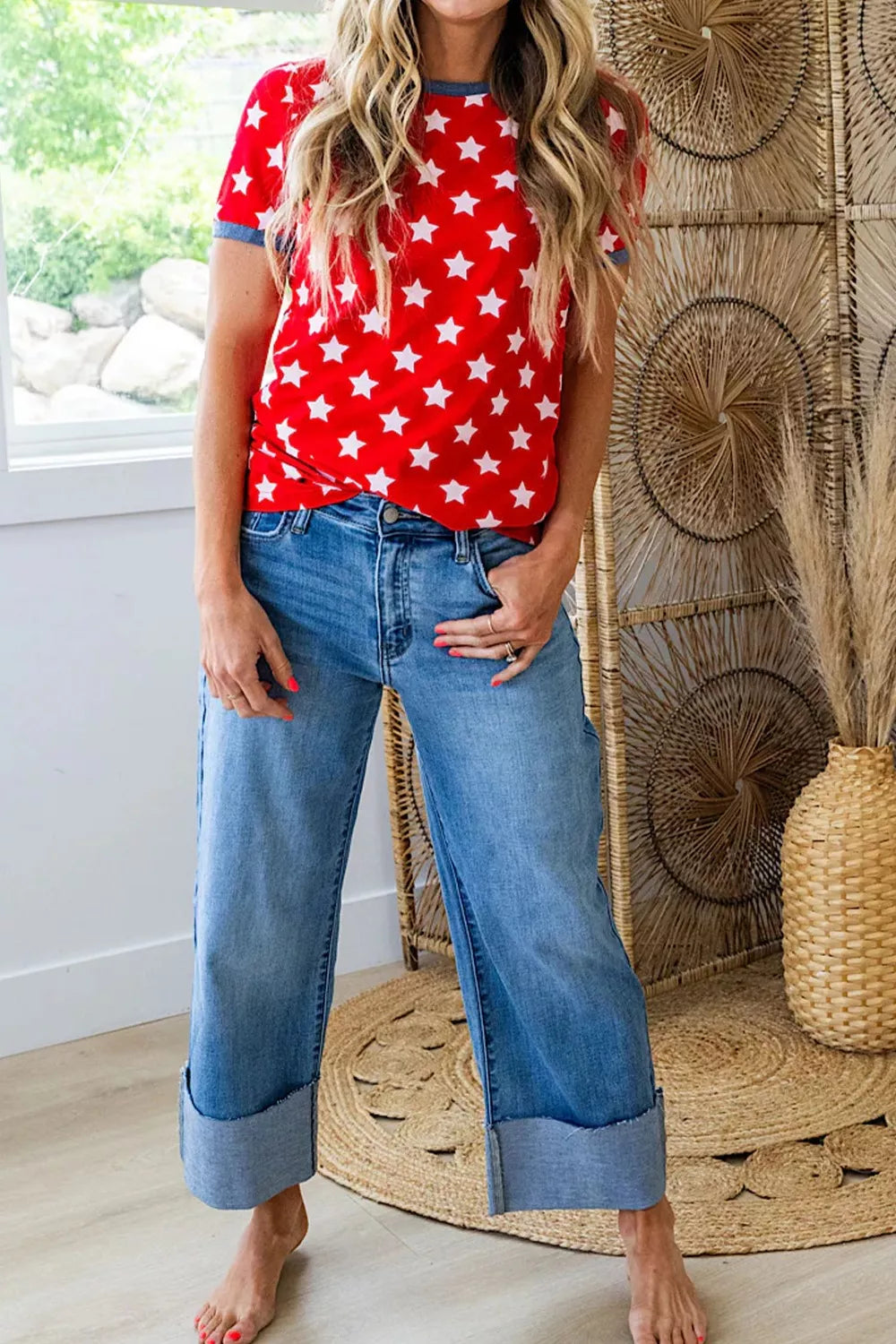 Starry red tunic t-shirt with blue trim and short sleeves, paired with cuffed wide-leg jeans.