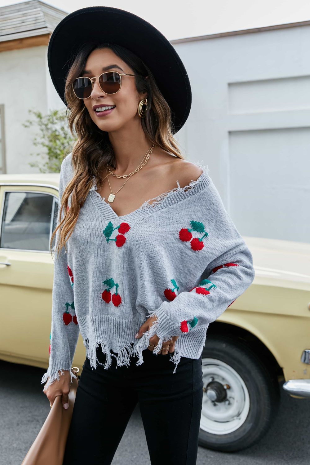 Gray cherry motif knit sweater with frayed hem and V-neck