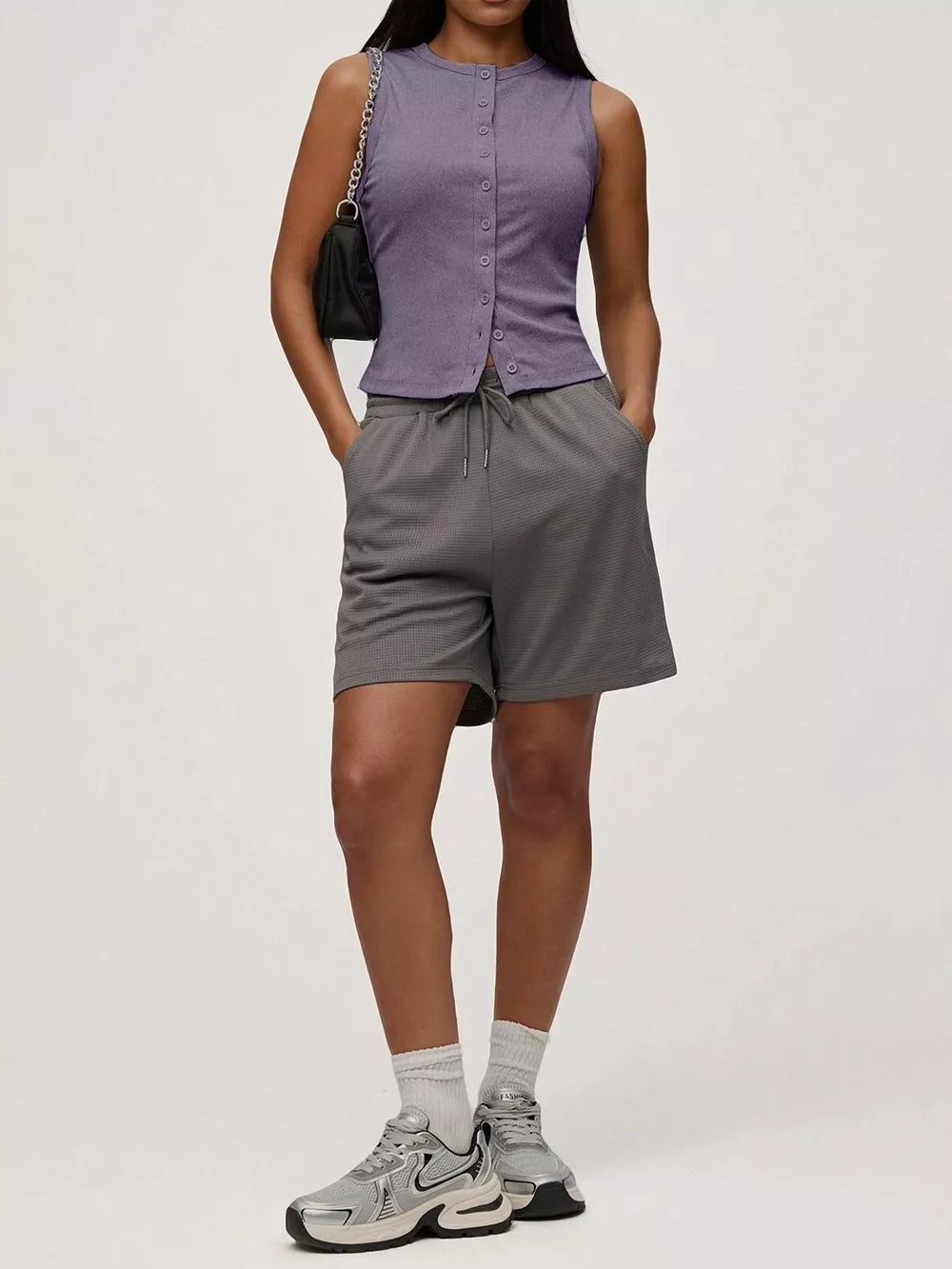 Dark purple ribbed button-front fitted tank top with a crew neck and sleeveless design.