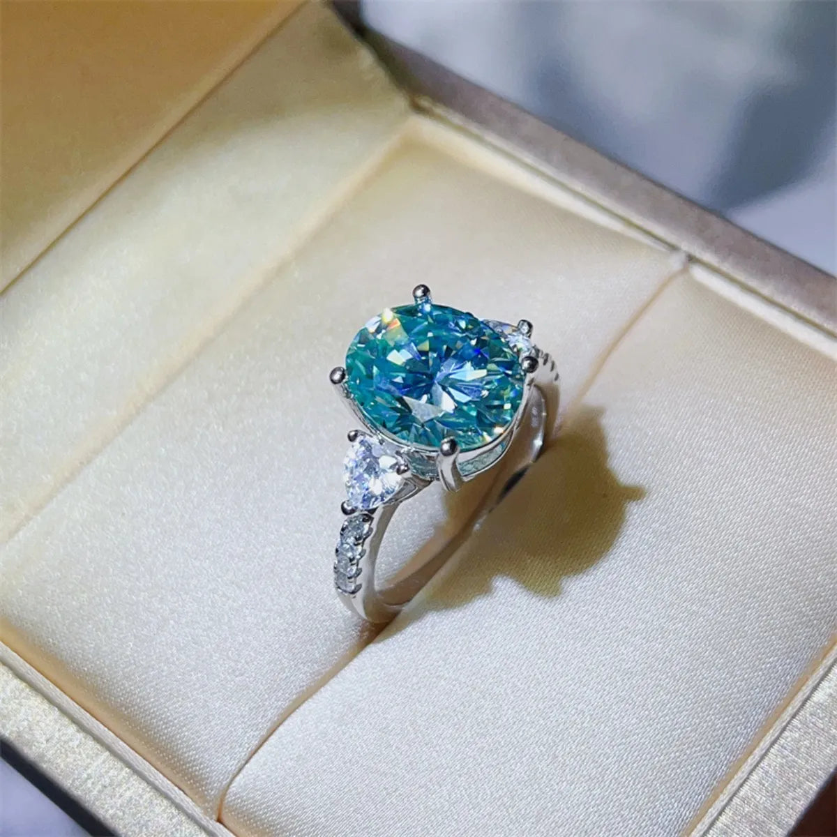 Turquoise moissanite trilogy ring in 925 sterling silver with oval and pear-shaped stones