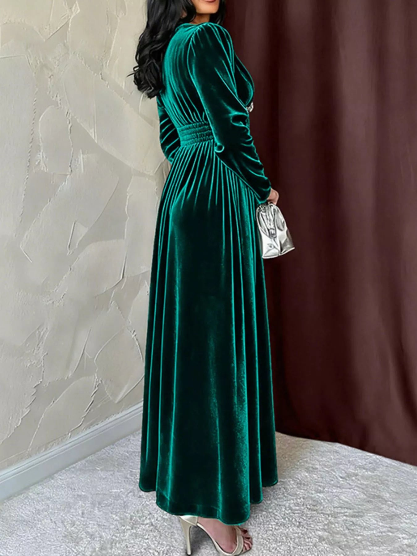 Green velvet ruched V-neck maxi dress with long sleeves and a cinched waist.