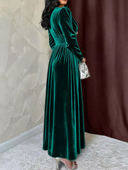 Green velvet ruched V-neck maxi dress with long sleeves and a cinched waist.