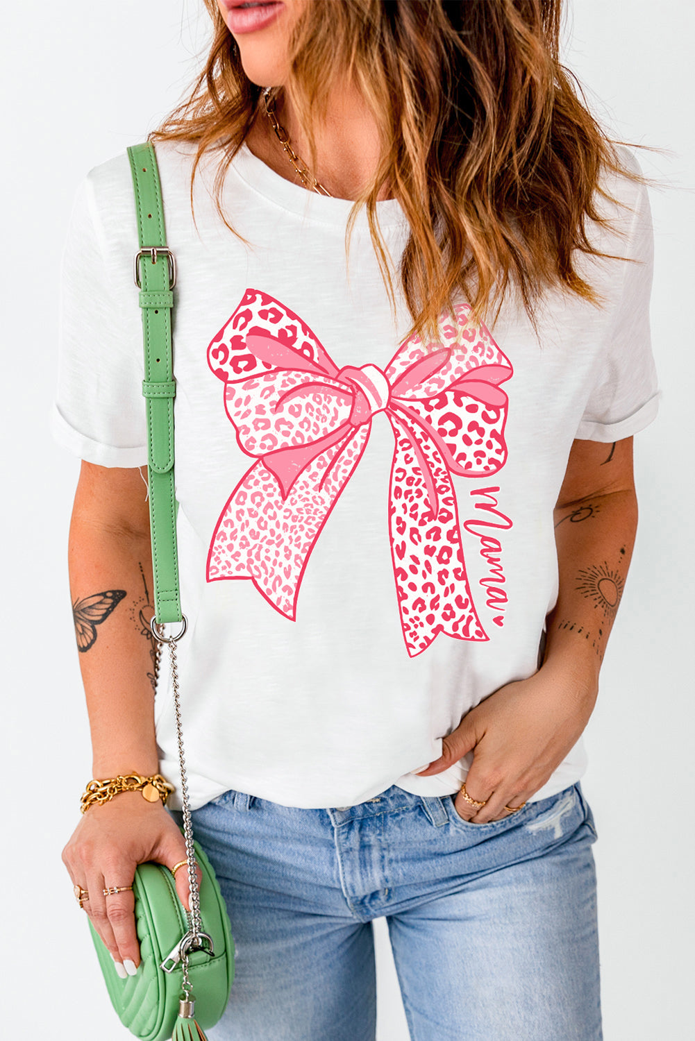 White maternity t-shirt with pink leopard print bow graphic and "Mama" text.