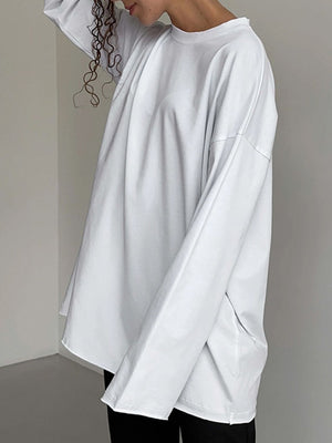 Oversized white cotton jersey long sleeve top with crew neck and relaxed fit.