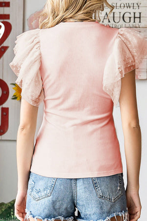 Blush pink ribbed knit blouse with sheer polka dot ruffle sleeves