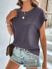 Woven texture cap-sleeve top in dark grey with a crew neck, styled casually with denim shorts.