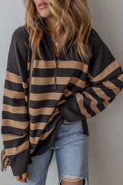 Oversized black and tan striped knit pullover with half-zip neckline and drop shoulders.