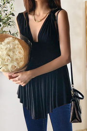 Black asymmetrical ruffle top with plunging neckline and sleeveless cut.