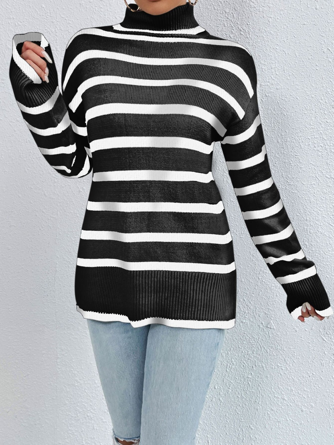 Oversized black and white striped turtleneck sweater with ribbed cuffs and hem.