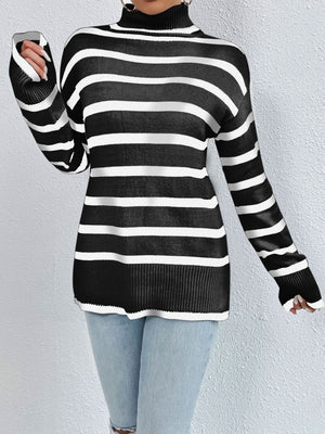 Oversized black and white striped turtleneck sweater with ribbed cuffs and hem.