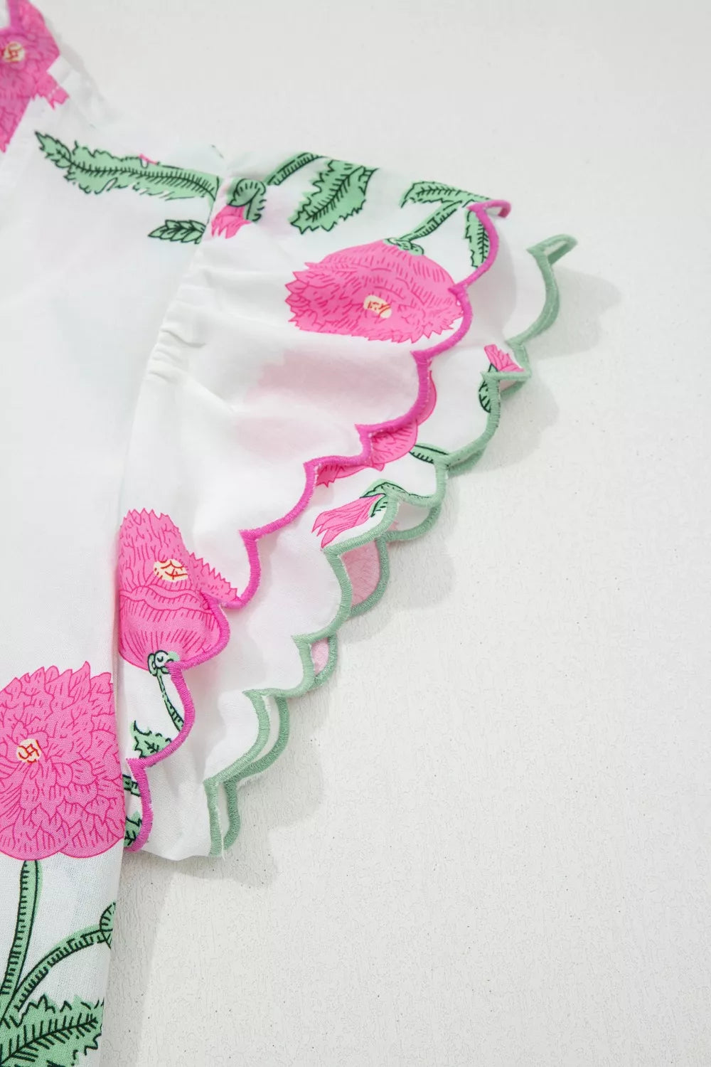 White cotton blouse with pink floral print and scalloped trim sleeves