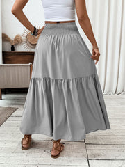 Gray ruffled smocked waist maxi skirt with tiered hem.