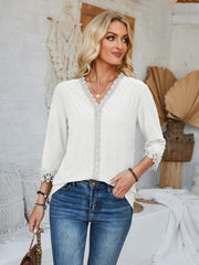 White eyelet blouse with V-neck and lace trim details on neckline and sleeves.