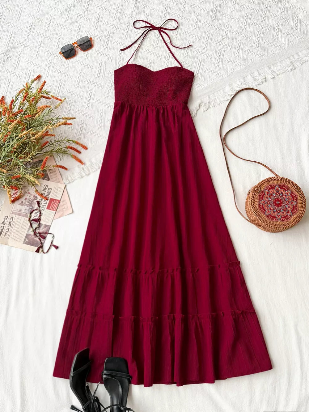 Burgundy halter neck tiered maxi dress with smocked bodice and sweetheart neckline.