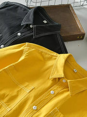 Yellow and black men's button-up shirts with contrast stitching and pockets.