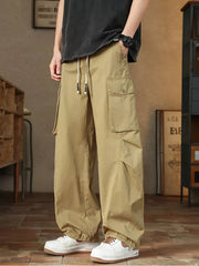 Khaki cargo pants with drawstring waist and multiple pockets.