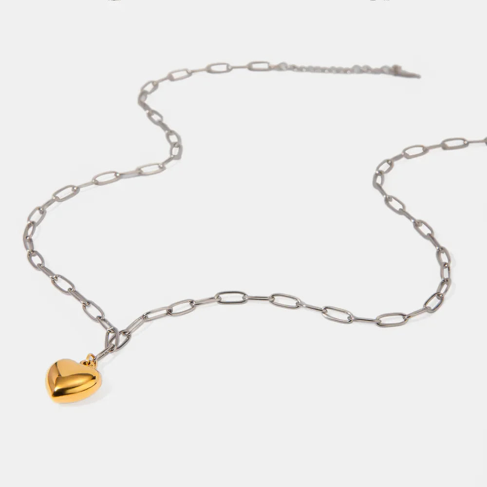 Two-tone heart pendant necklace with silver chain and gold heart charm.
