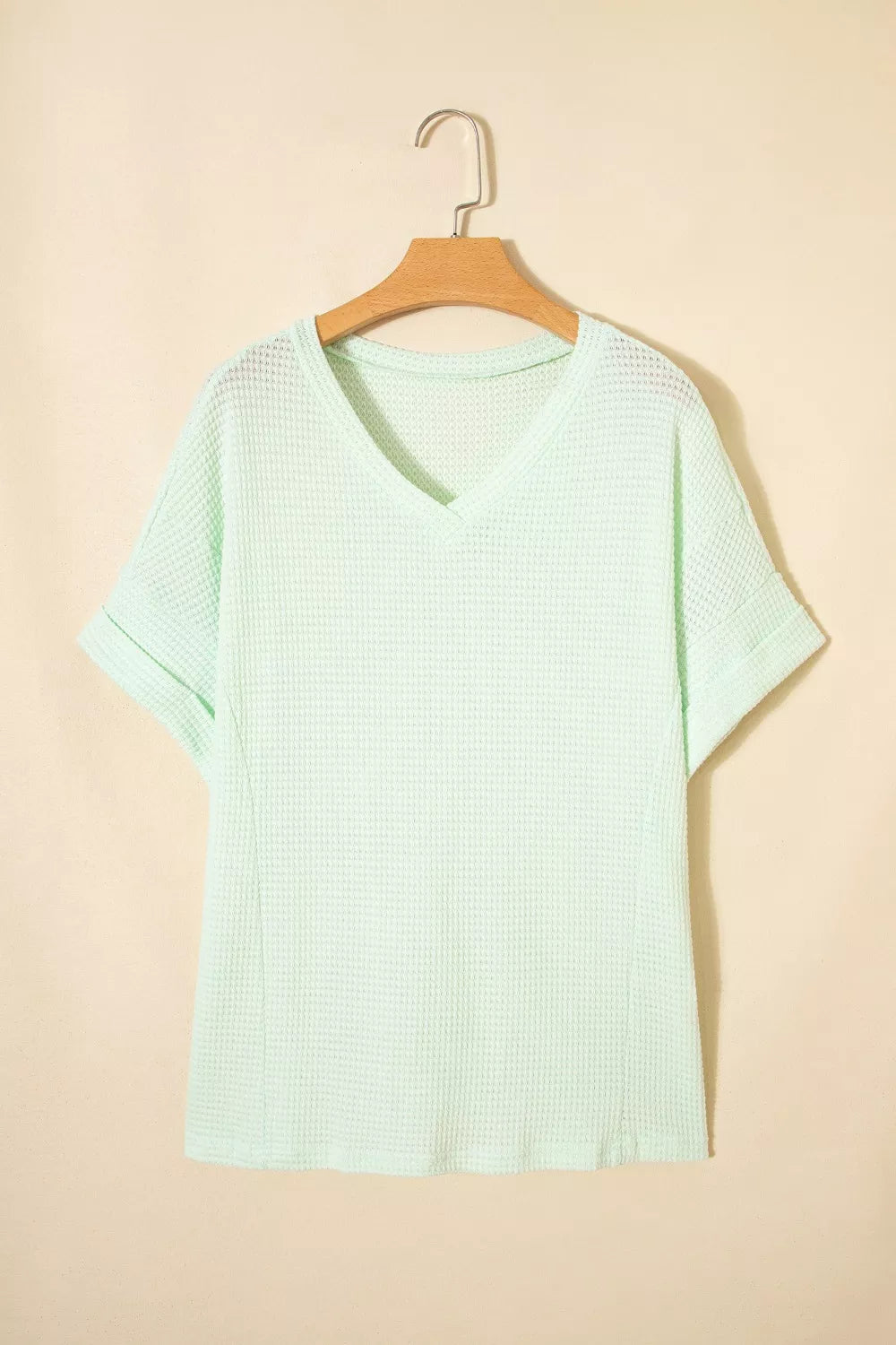 Light green waffle knit V-neck t-shirt with cuffed short sleeves.