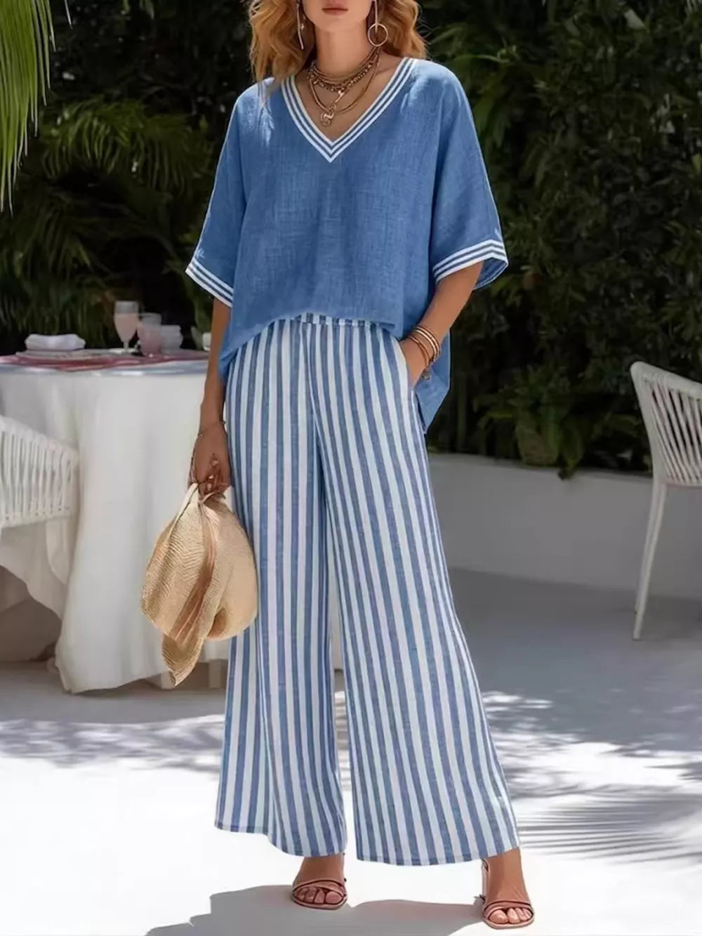 Blue striped V-neck top and wide-leg pants set with white trim detail.
