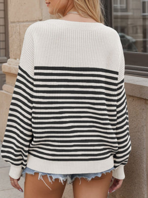 Cream and black striped drop shoulder knit sweater with a crew neck.