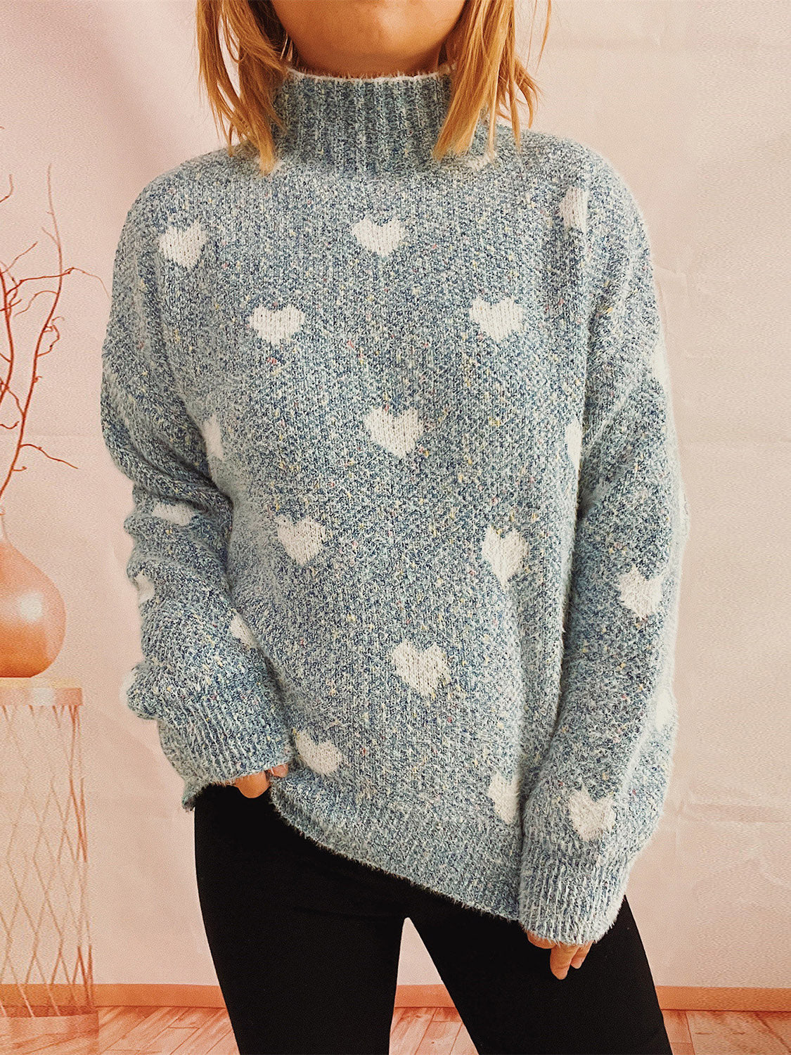 Textured acrylic turtleneck sweater in Mint Blue with a white heart motif.