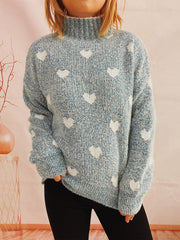 Textured acrylic turtleneck sweater in Mint Blue with a white heart motif.