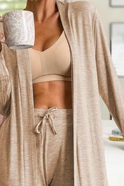 Tan duster cardigan and joggers set with drawstring waist, worn with a nude bra.