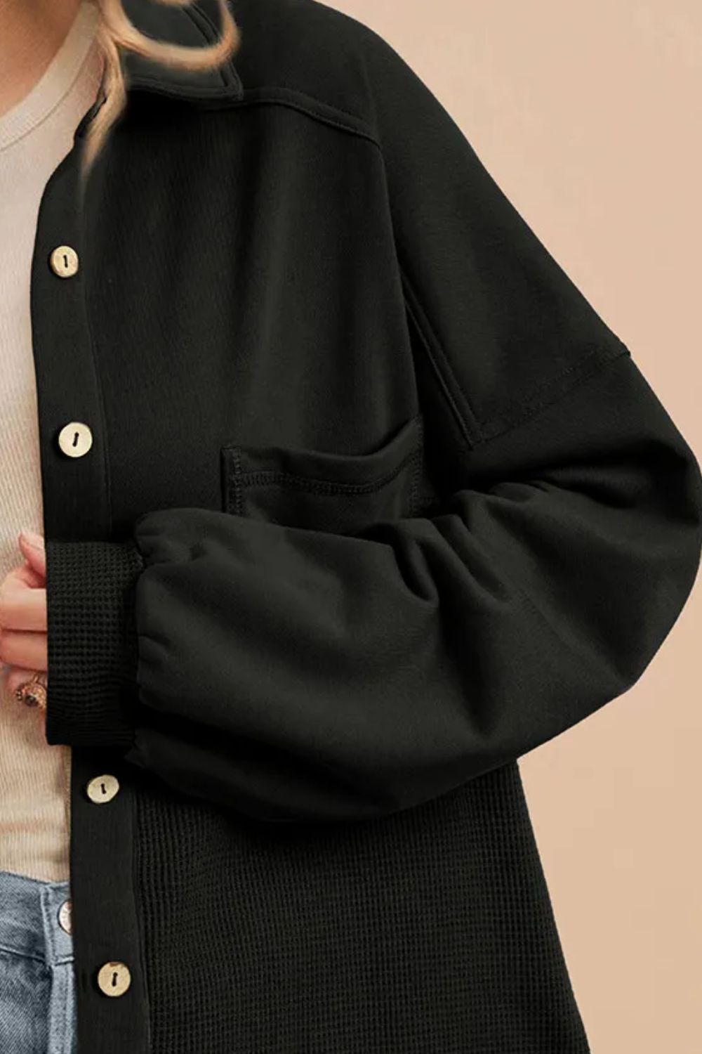 Black waffle knit shacket with gathered sleeves, button front, and chest pocket.