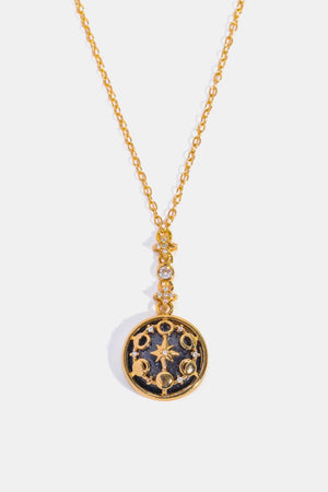 Gold celestial medallion pendant necklace with moon phases and star details.