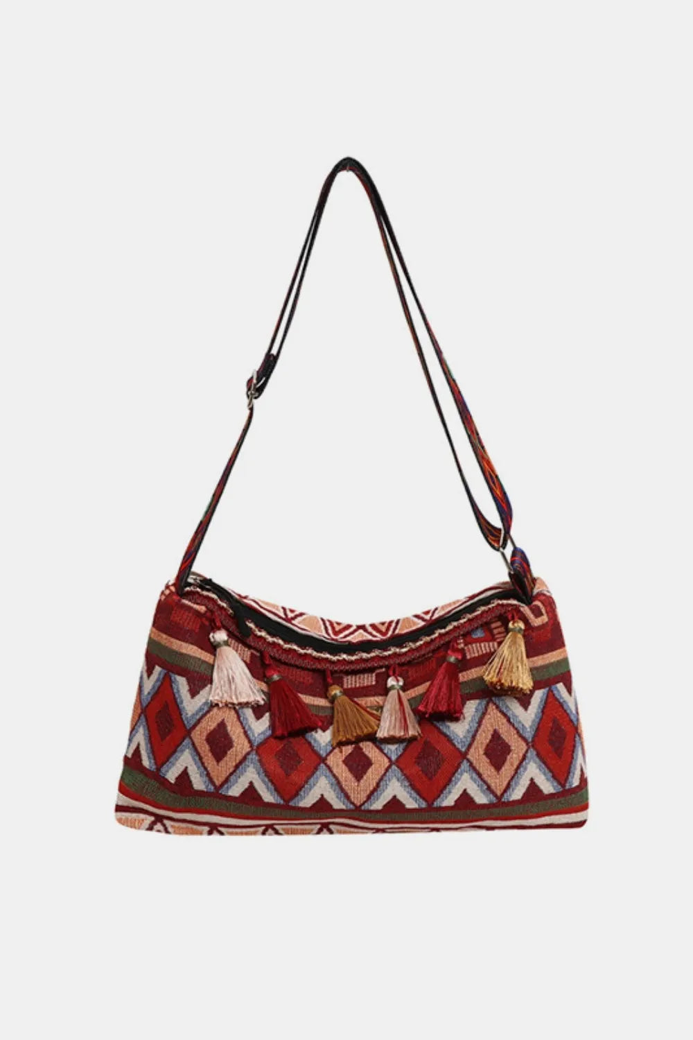 Geometric embroidered shoulder bag in deep red with multicolor tassels and woven pattern.