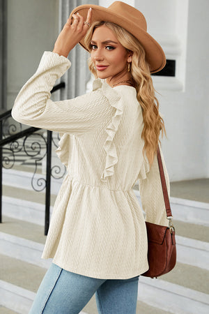 Cream textured peplum blouse with ruffle detail and long sleeves.