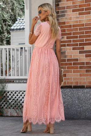 Peach lace midi dress with short sleeves and scalloped hem, styled with heels.