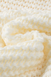 Textured knit cocoon cardigan in pastel yellow acrylic with chunky stitches.