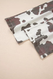 Cow print jeans with utility pockets and a cotton blend fabric.