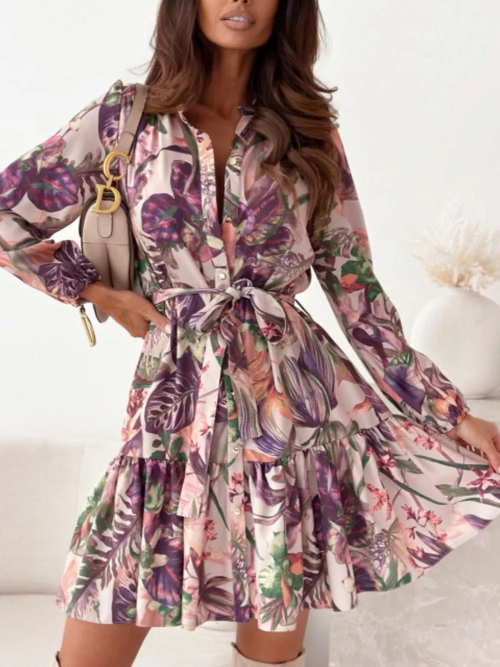 Delicate floral tie-waist mini dress with button-down front and tiered skirt.