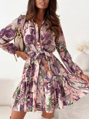Delicate floral tie-waist mini dress with button-down front and tiered skirt.