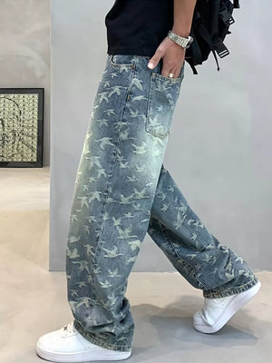 Loose-fit jeans with all-over bird print in light wash denim.