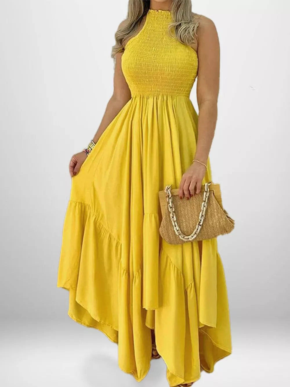Yellow smocked maxi dress with ruffle hem and halter neckline.
