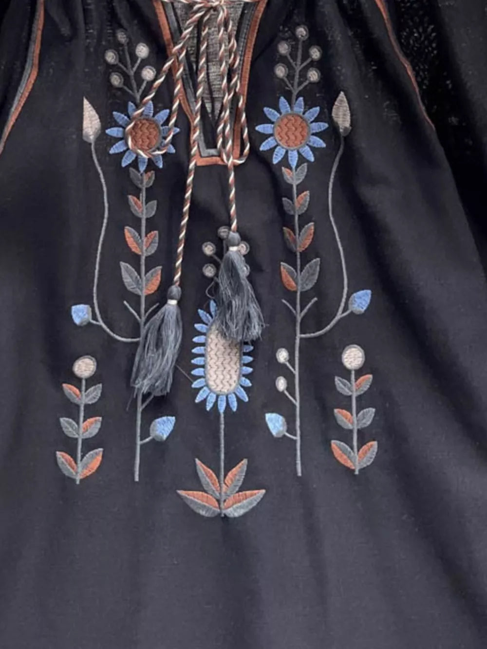 Black embroidered tie neck blouse with floral detail and tassels