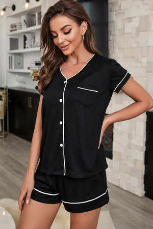 Black button-down pajama set with white piping and short sleeves