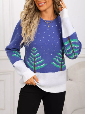 Blue acrylic sweater with evergreen trees and snow pattern, color block sleeves.
