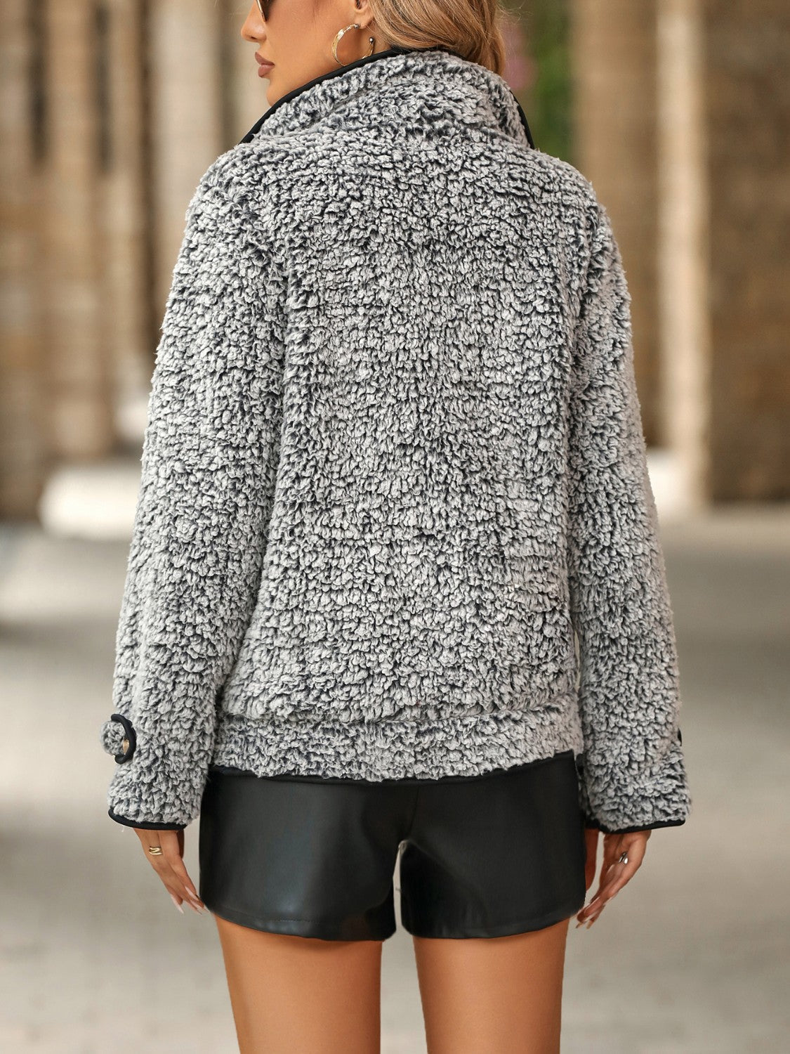 Sherpa jacket with black piping and button detail, shown from the back.